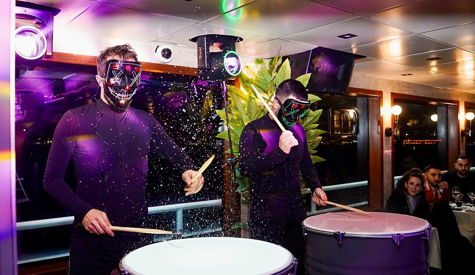 Drum show with illuminated masks on board